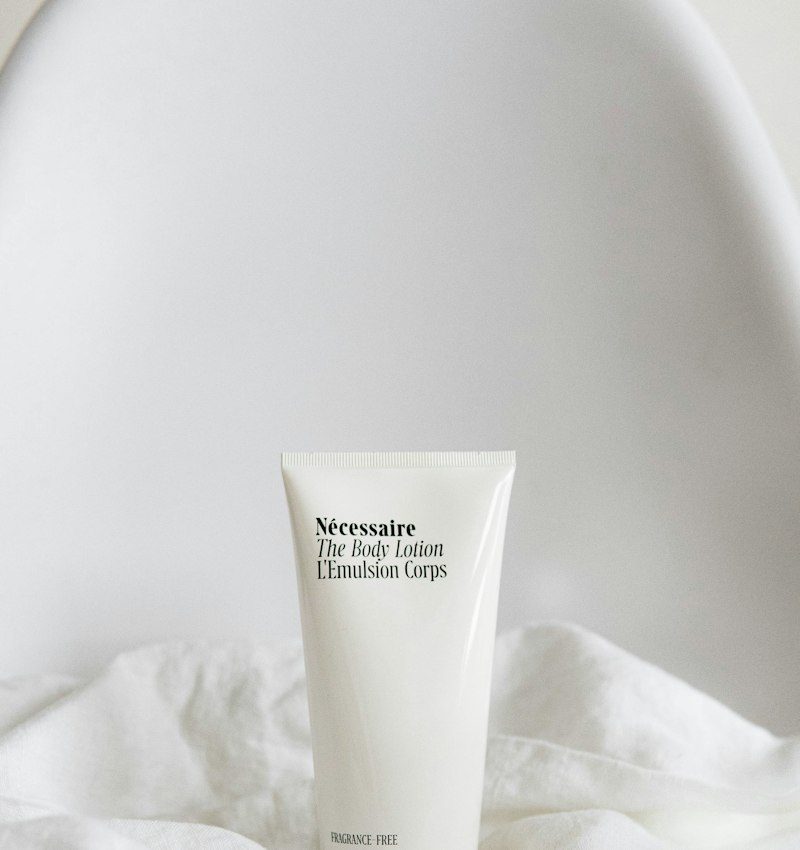 Body lotion tube on a soft towel